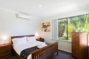 a bedroom with a bed and a large window at Seahaven by Rockingham Apartments in Rockingham