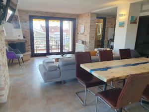 a living room with a table and chairs at Teo`s Seaview Specious Apartment, Nikiti near Harbor in Nikiti