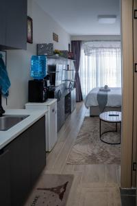 a kitchen and a living room with a bed at Taurus B8-6 in Nairobi +11 photos