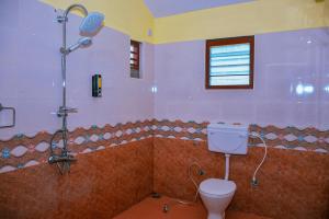 a bathroom with a shower and a toilet in it at Pleasant Memories in Kodaikānāl +51 photos