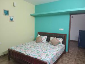 a bedroom with a bed with pillows on it at Pleasant Memories in Kodaikānāl