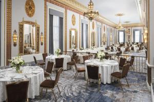 a dining room with tables and chairs and mirrors at Hilton Milwaukee in Milwaukee