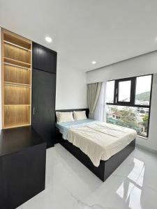 a bedroom with a bed and a large window at TA Nhatrang Apartment in Nha Trang +26 photos