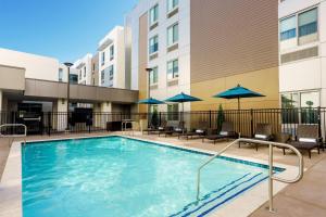 a pool at a hotel with chairs and umbrellas at Homewood Suites By Hilton San Jose Santa Clara in San Jose