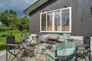 a group of chairs and a table on a patio at テントサウナがある家 余市町 in Kurokawamachi +42 photos