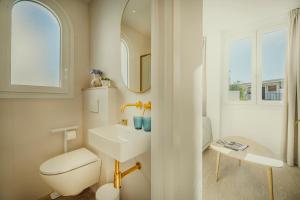 a bathroom with a sink and a toilet and a mirror at Beneste Nerja Hostal in Nerja +37 photos