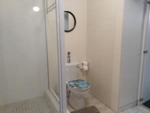 a bathroom with a toilet and a shower at Ryans Surf Cabin in Jeffreys Bay +15 photos