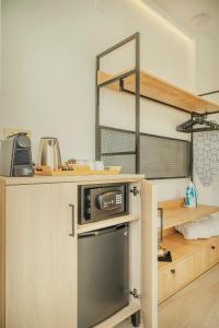 a kitchen with a bunk bed with a microwave on a counter at Beneste Nerja Hostal in Nerja