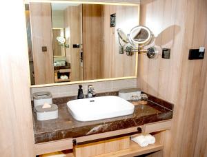 a bathroom with a sink and a mirror at Atour Hotel High Speed Railway North Station Zibo Hi tech Zone in Zibo
