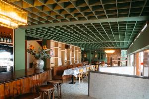 a dining room with tables and chairs and a green ceiling at Céline & Lolo in Nairobi