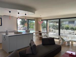 a kitchen and living room with a couch and a table at luxe et sérénité in Lecci