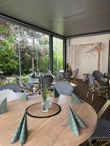 a room with a table and chairs and a large window at penzion rustico s.r.o. in Bučovice