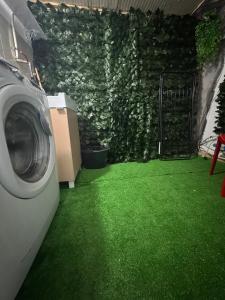 a washing machine in a yard with green grass at Duba Holiday House in Palermo