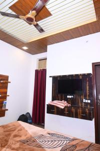 a bedroom with a ceiling fan and a fireplace at Hotel Royal Vista in Meerut