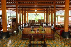a room with tables and chairs in a building at Joglo Mandapa Boutique Hotel in Yogyakarta