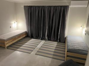 a bedroom with two beds and a window at Emmaste Apartment in Emmaste +4 photos
