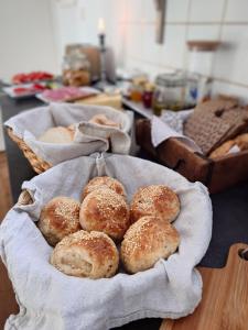 a bunch of breads in baskets on a table at Ales BnB in Löderup