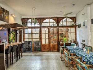 a restaurant with tables and chairs and a bar at Captain Purunchi in Cotonou