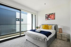 a bedroom with a bed and a large window at 4BR Spacious Townhouse in Box Hill in Annangrove