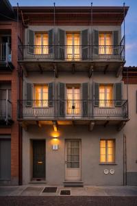 an apartment building with windows and balconies at Casa Botanica - Boutique Apartment nel centro di Alba in Alba