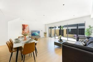 a living room with a table and a couch at 4BR Spacious Townhouse in Box Hill in Annangrove