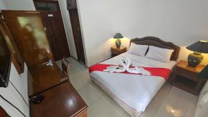 a bedroom with a bed with shoes on it at Dekuningan Executive in Jakarta