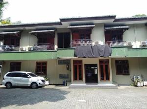 a white car parked in front of a building at Dekuningan Executive in Jakarta