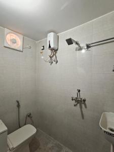 a bathroom with a toilet and a camera on the wall at Shivprasad homestay in Varanasi