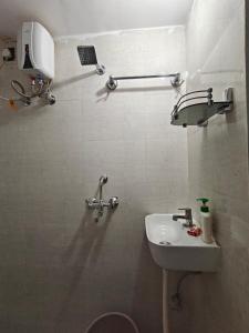 a small bathroom with a sink and a toilet at Shivprasad homestay in Varanasi