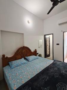 a bedroom with a bed with a blue comforter at Shivprasad homestay in Varanasi