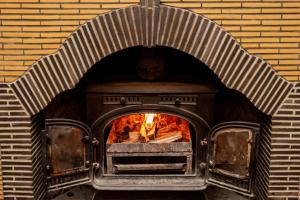 a brick oven with a fire in it at Camps Bay Retreat Hotel in Cape Town