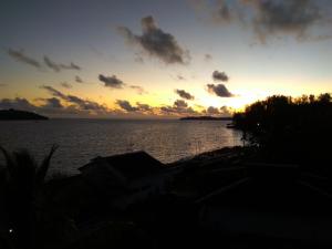 a sunset over a large body of water at The Seaview Residency in Port Blair