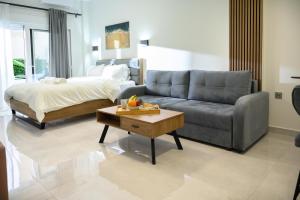 a living room with a couch and a bed at Coastline 1 in Perea