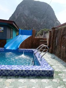 a swimming pool with a water slide in a house at Faridd homestay in Kampung Titi Tampang