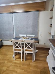 a dining room with a table and four chairs at apartamento castelao in Cedeira +8 photos