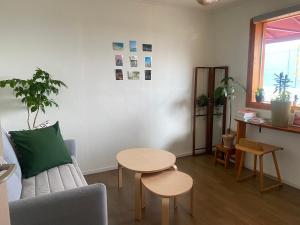 a living room with a couch and a table at 산초리니 Sanchorini in Busan