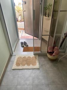a bathroom with a shower and a rug on the floor at 산초리니 Sanchorini in Busan
