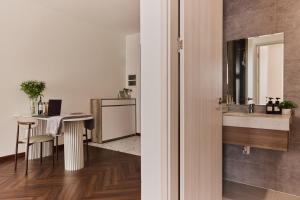a bathroom with a sink and a table with a desk at HongHome Compass One in Ga Phú Văn +169 photos