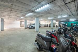 a group of motorcycles parked in a parking lot at Hotel Hycon in Kozhikode