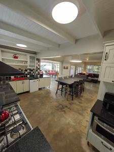 a large kitchen with a table and chairs in it at Karibu Self-catering Accommodation in Hermanus