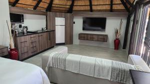a bedroom with a bed and a tv in a room at Bootleg Inn in Welkom
