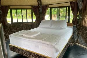 a large white bed in a room with windows at Honey Queen Resort in Ban Tha Manao +184 photos