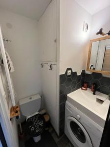 a bathroom with a washing machine and a sink at Ada & Cimes in Bourg-Saint-Maurice +3 photos