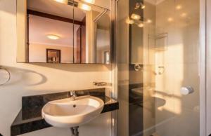 a bathroom with a sink and a mirror at 19 Lagoon Terrace in Knysna +3 photos