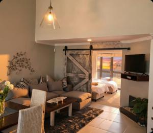 a living room with a couch and a bed at 19 Lagoon Terrace in Knysna