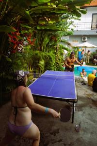 a woman in a bikini playing a table tennis at What The Duck Backpackers in Canggu
