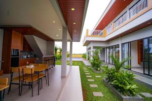 an internal courtyard of a house with a table and chairs at Pondok Uma Jero in Tanah Lot