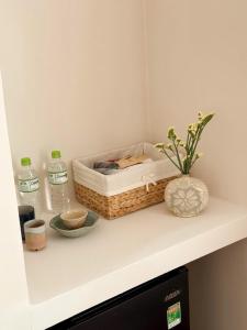 a shelf with a basket and other items on it at GÓC MƠ home in Da Thanh