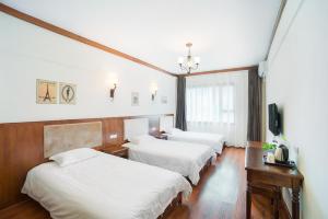Postel nebo postele na pokoji v ubytování Memory Inn Guilin Central