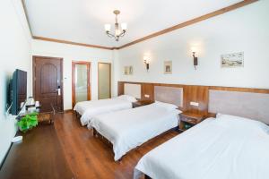 Postel nebo postele na pokoji v ubytování Memory Inn Guilin Central
